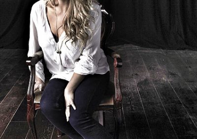 image of pianist Jennie sitting on a wooden stage